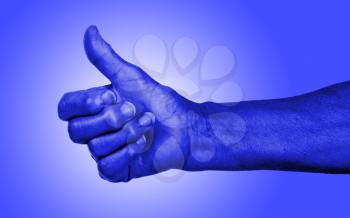 Old woman with arthritis giving the thumbs up sign, blue skin