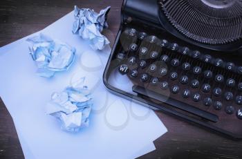 Close-up of an old typewriter with paper, cold vintage look
