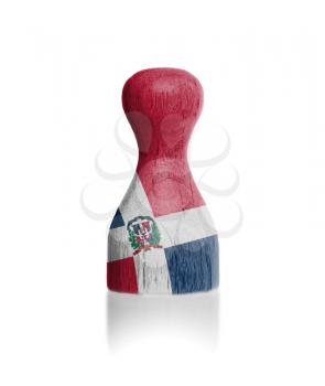 Wooden pawn with a painting of a flag, Dominican Republic