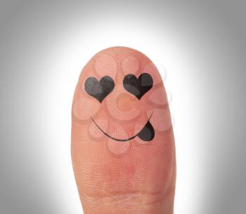 Female thumbs with smile face on the finger, being in love