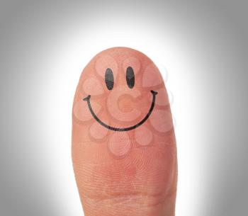 Female thumbs with smile face on the finger, happy