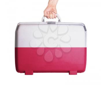 Used plastic suitcase with stains and scratches, printed with flag, Poland