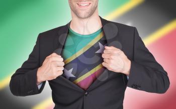 Businessman opening suit to reveal shirt with flag, Saint Kitts and Nevis