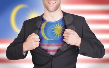 Businessman opening suit to reveal shirt with flag, Malaysia