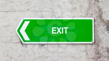Green sign on a concrete wall - Exit