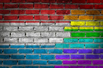 Dark brick wall texture - coutry flag and rainbow flag painted on wall - Luxembourg