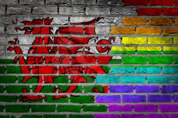 Dark brick wall texture - coutry flag and rainbow flag painted on wall - Wales