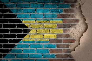 Dark brick wall texture with plaster - flag painted on wall - Bahamas