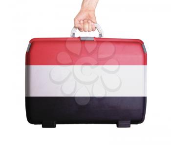 Used plastic suitcase with stains and scratches, printed with flag, Yemen