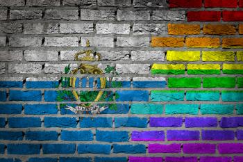 Dark brick wall texture - coutry flag and rainbow flag painted on wall - San Marino
