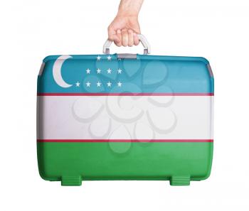 Used plastic suitcase with stains and scratches, printed with flag, Uzbekistan