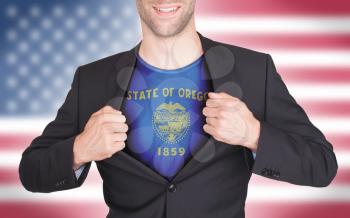 Businessman opening suit to reveal shirt with state flag (USA), Oregon
