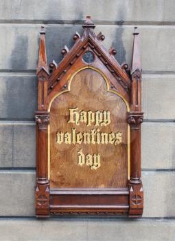 Decorative wooden sign hanging on a concrete wall - Happy valentines day