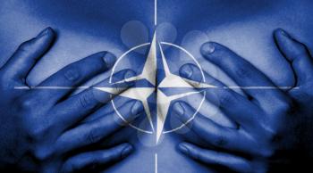 Upper part of female body, hands covering breasts, NATO