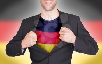 Businessman opening suit to reveal shirt with flag, Germany
