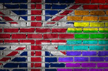 Dark brick wall texture - coutry flag and rainbow flag painted on wall - United Kingdom