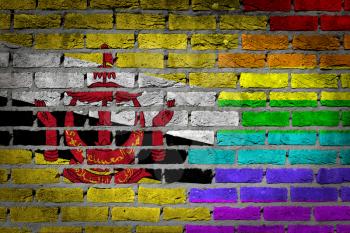 Dark brick wall texture - coutry flag and rainbow flag painted on wall - Brunei