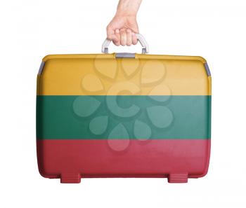 Used plastic suitcase with stains and scratches, printed with flag, Lithuania