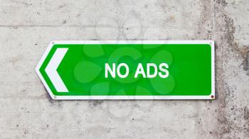 Green sign on a concrete wall - No ads