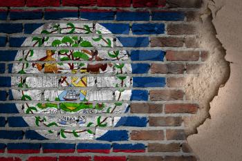 Dark brick wall texture with plaster - flag painted on wall - Belize