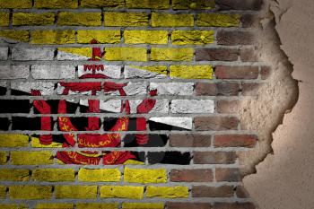 Dark brick wall texture with plaster - flag painted on wall - Brunei