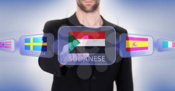 Hand pushing on a touch screen interface, choosing language or country, Sudan