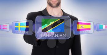 Hand pushing on a touch screen interface, choosing language or country, Tanzania