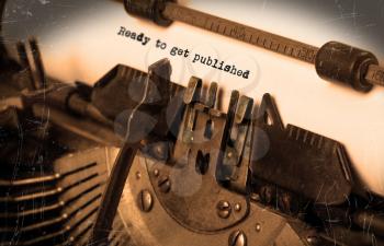 Close-up of an old typewriter with paper, selective focus, ready to get published