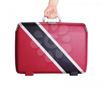 Used plastic suitcase with stains and scratches, printed with flag, Trinidad and Tobago