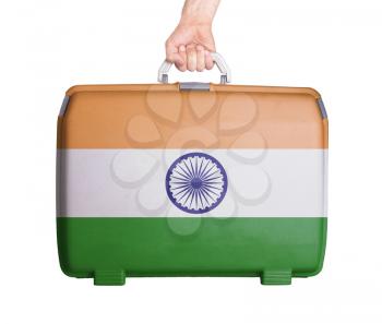 Used plastic suitcase with stains and scratches, printed with flag, India