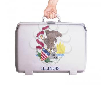 Used plastic suitcase with stains and scratches, printed with flag, Illinois