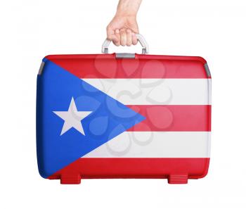 Used plastic suitcase with stains and scratches, printed with flag, Puerto Rico