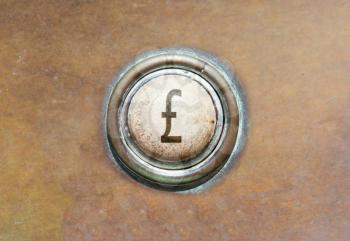 Grunge image of an old button - british pound