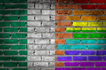 Dark brick wall texture - coutry flag and rainbow flag painted on wall - Ireland