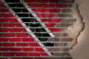 Dark brick wall texture with plaster - flag painted on wall - Trinidad and Tobago