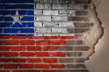 Dark brick wall texture with plaster - flag painted on wall - Chile