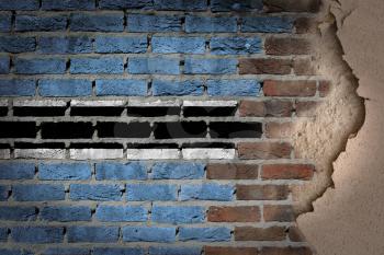 Dark brick wall texture with plaster - flag painted on wall - Botswana
