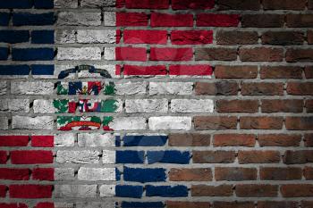 Very old dark red brick wall texture with flag - Dominican Republic