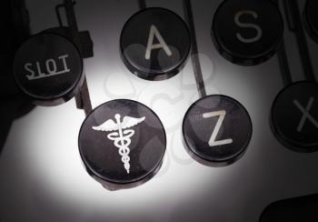 Typewriter with special buttons, doctor symbol