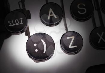 Typewriter with special buttons, smiley