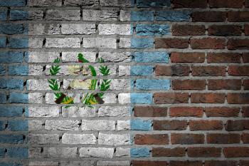 Very old dark red brick wall texture with flag - Guatemala