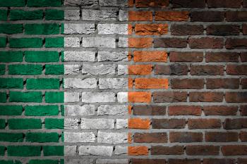 Very old dark red brick wall texture with flag - Ireland
