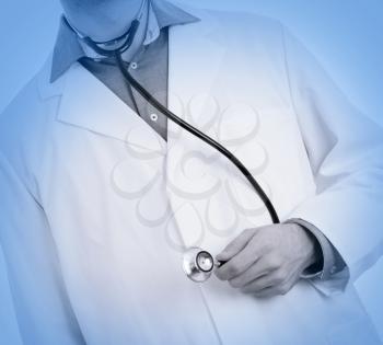 Close up of a Doctor's hand, holding a stethoscope, isolated, medical blue