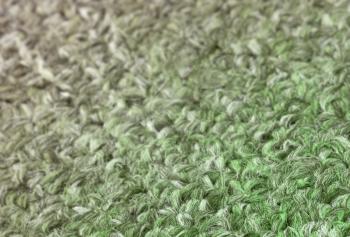 Carpet texture close-up, green furry carpet texture background, selective focus