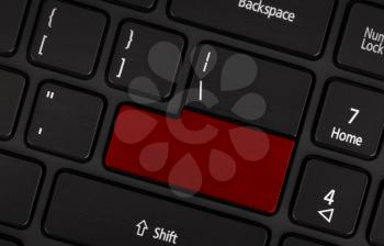 Laptop computer keyboard with blank red button for text