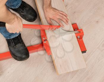 Red tool for cutting laminate on a laminate floor