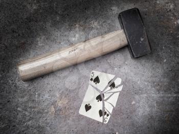 Hammer with a broken card, vintage look, five of spades