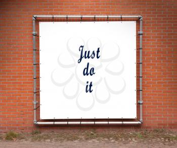 Large banner with inspirational quote on a brick wall - Just do it
