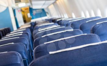 Empty old blue airplane seats in the cabin, selective focus