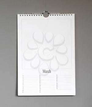 Simple old birthday calendar hanging on a grey wall, copy space - March